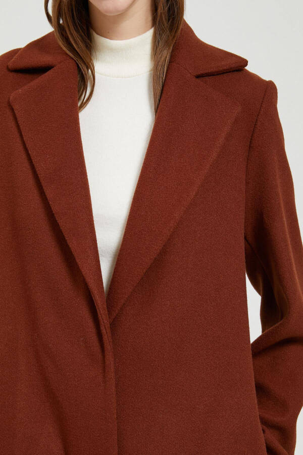 A woman's brown coat. - 5