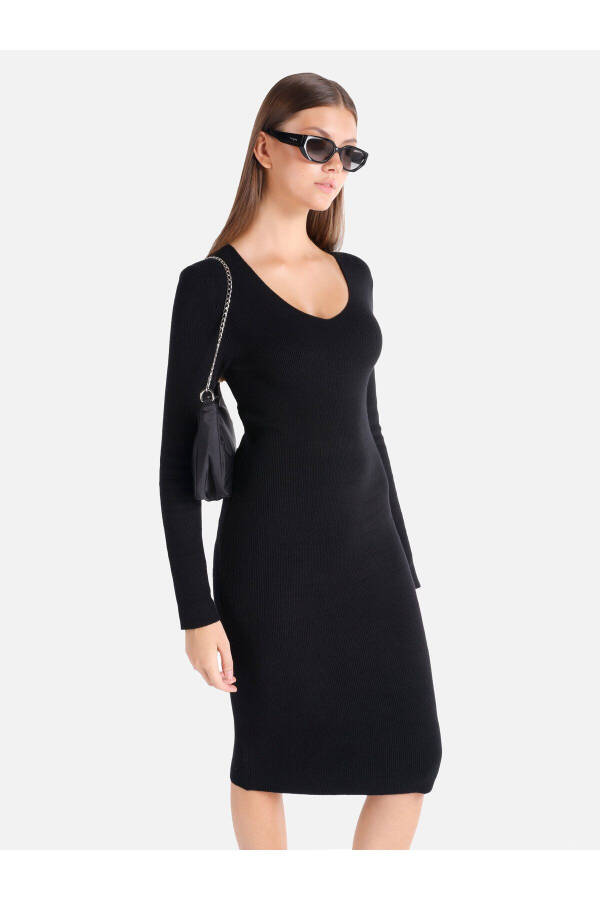 Black midi dress with a V-neck and a fitted silhouette. - 1