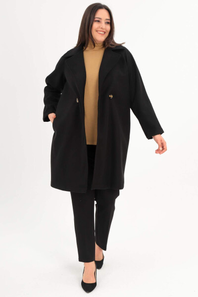 Black oversized coat with button details. - 1