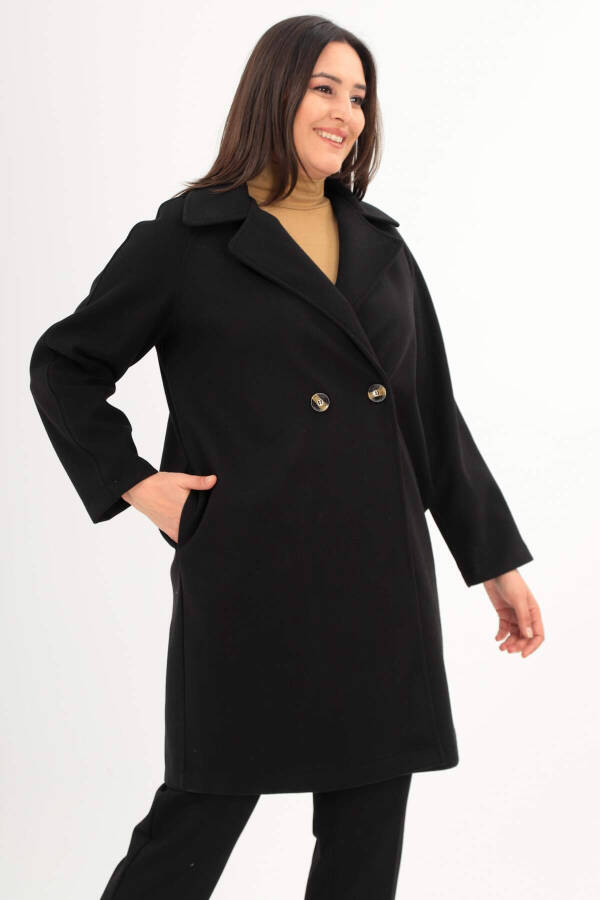 Black oversized coat with button details. - 2