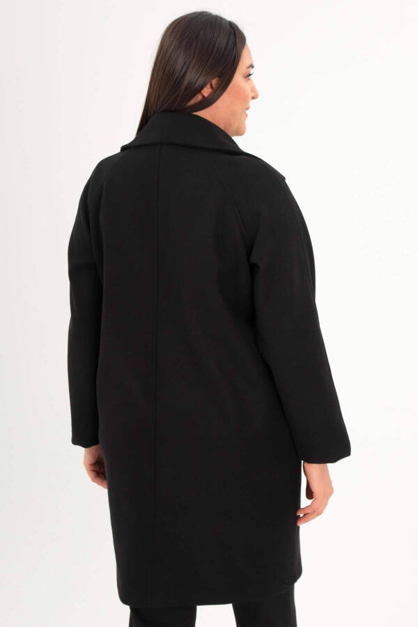 Black oversized coat with button details. - 5