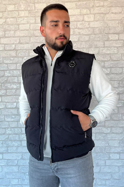 Black puffer vest for men, with an emblem detail. - 1