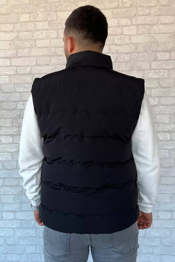 Black puffer vest for men, with an emblem detail. - 3