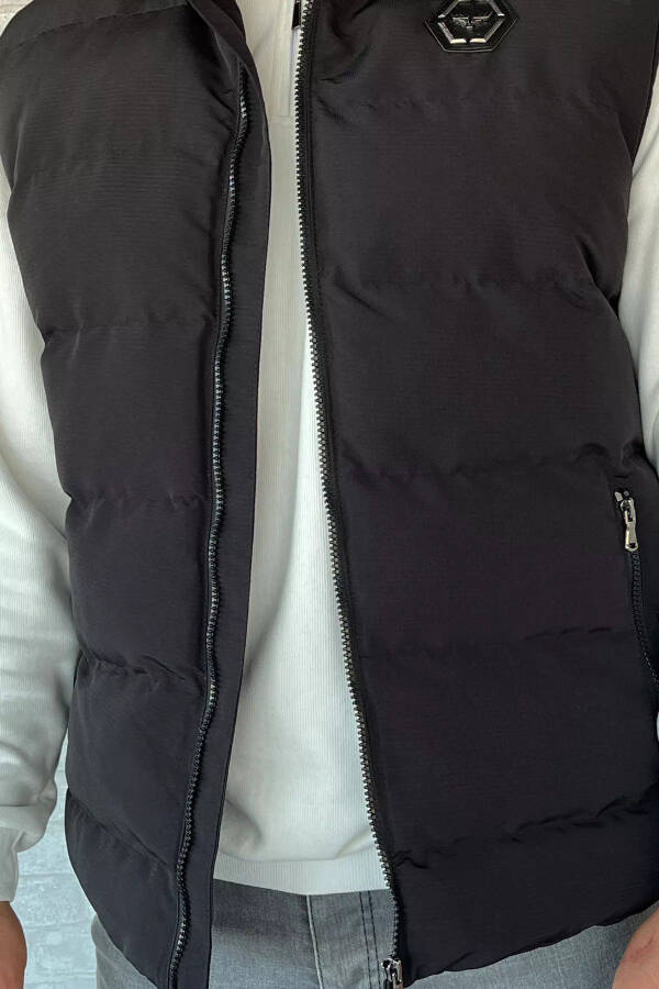 Black puffer vest for men, with an emblem detail. - 4