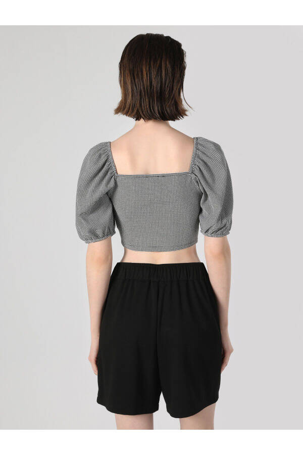 Black, short-sleeved, crop top with a square neckline and print. - 2