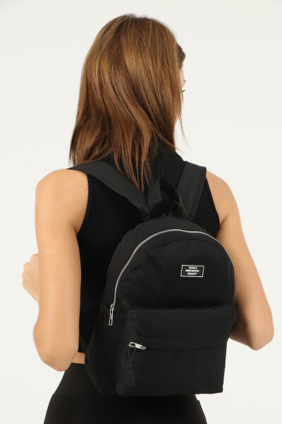 Black unisex backpack with 2 front pockets and zipper, made of canvas fabric. U: 32 cm W: 24 cm D: 11 cm - 4