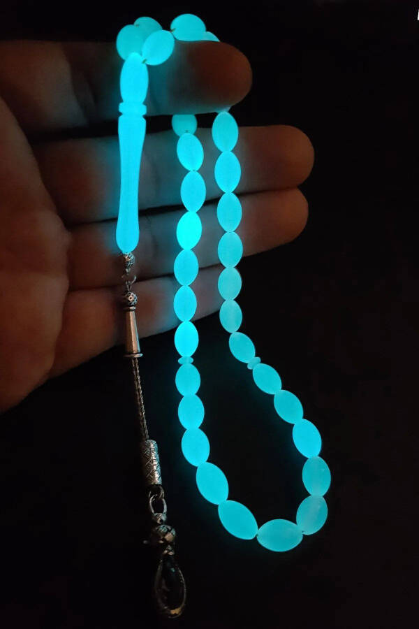 Blue phosphorescent barley cut cat's eye rosary. - 1