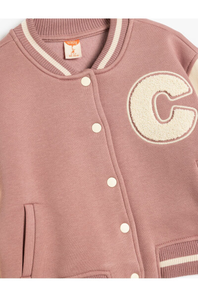 College jacket with fleece lining, applique details, pockets and snap closure. - 6