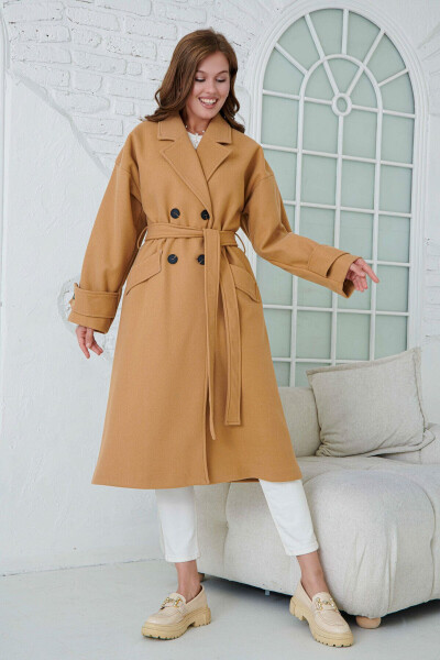 Double-breasted, buttoned, belted, long-sleeved, dropped shoulder, lined midi length camel coat. - 2