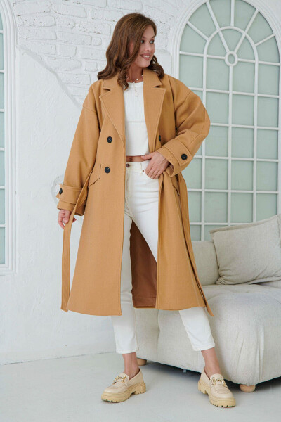 Double-breasted, buttoned, belted, long-sleeved, dropped shoulder, lined midi length camel coat. - 5