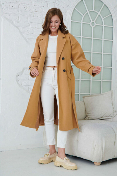 Double-breasted, buttoned, belted, long-sleeved, dropped shoulder, lined midi length camel coat. - 7