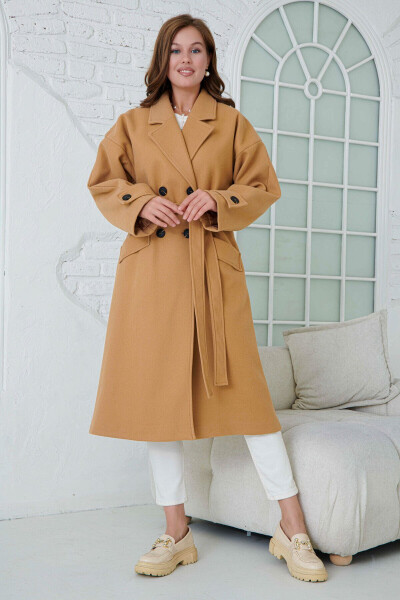 Double-breasted, buttoned, belted, long-sleeved, dropped shoulder, lined midi length camel coat. - 8