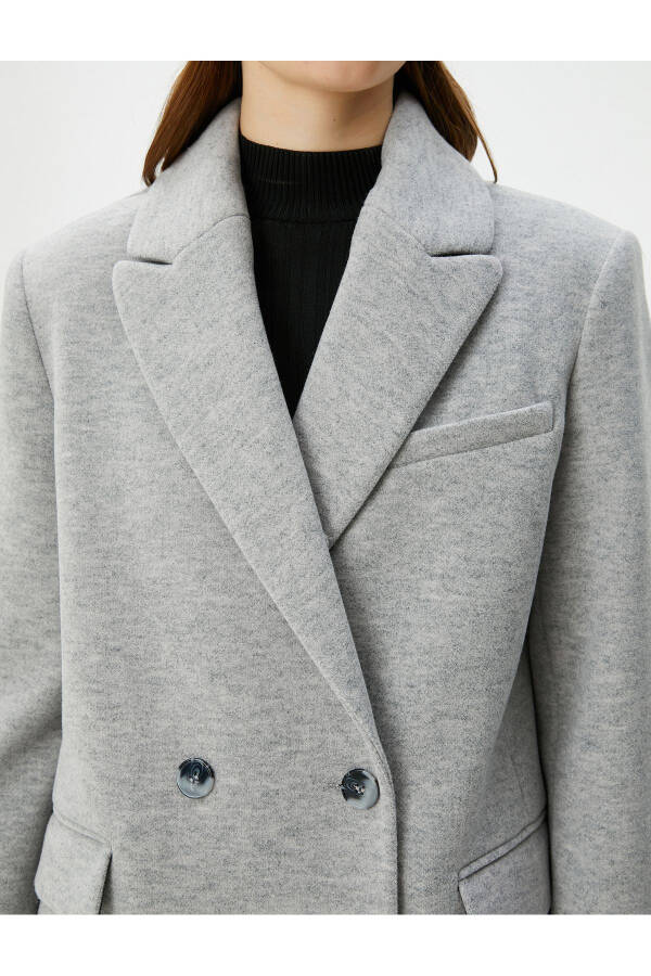 Double-breasted coat with buttoned pocket detail. - 13