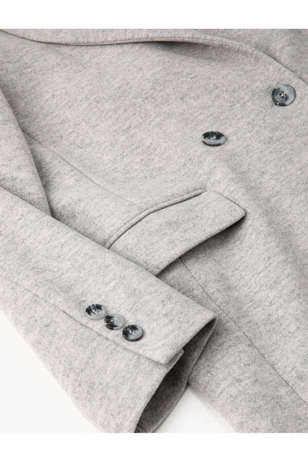 Double-breasted coat with buttoned pocket detail. - 15