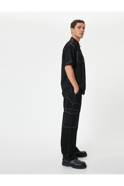 Oversized cargo pants with contrasting color details and wide legs. - 8