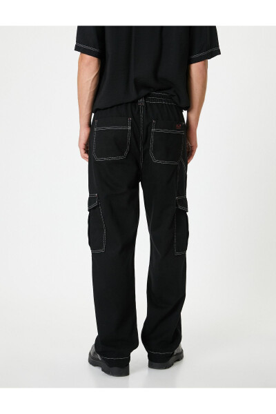 Oversized cargo pants with contrasting color details and wide legs. - 10