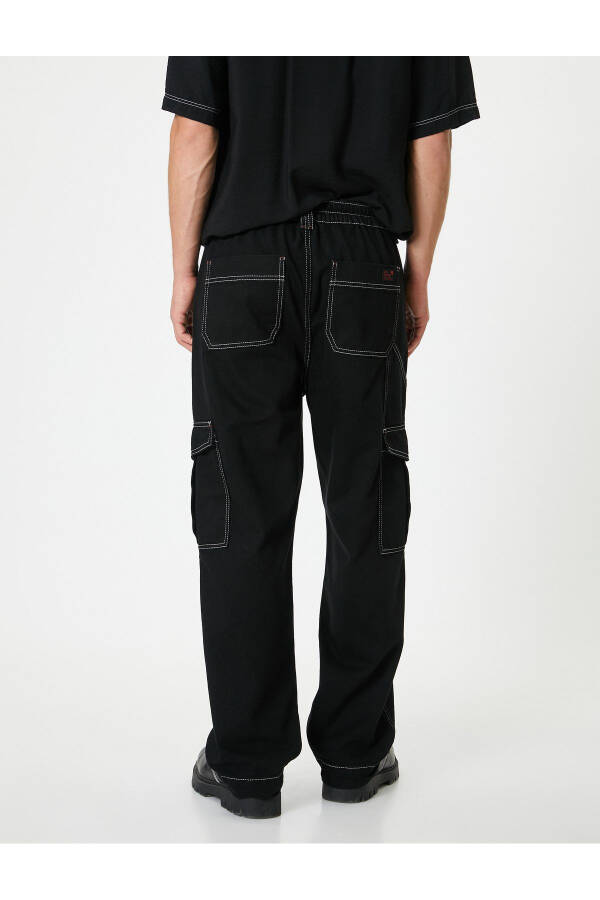 Oversized cargo pants with contrasting color details and wide legs. - 10