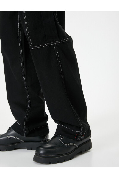 Oversized cargo pants with contrasting color details and wide legs. - 11