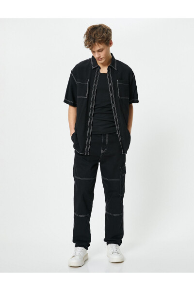 Oversized denim pants with cargo pockets, stitch detailing and buttons. - 8