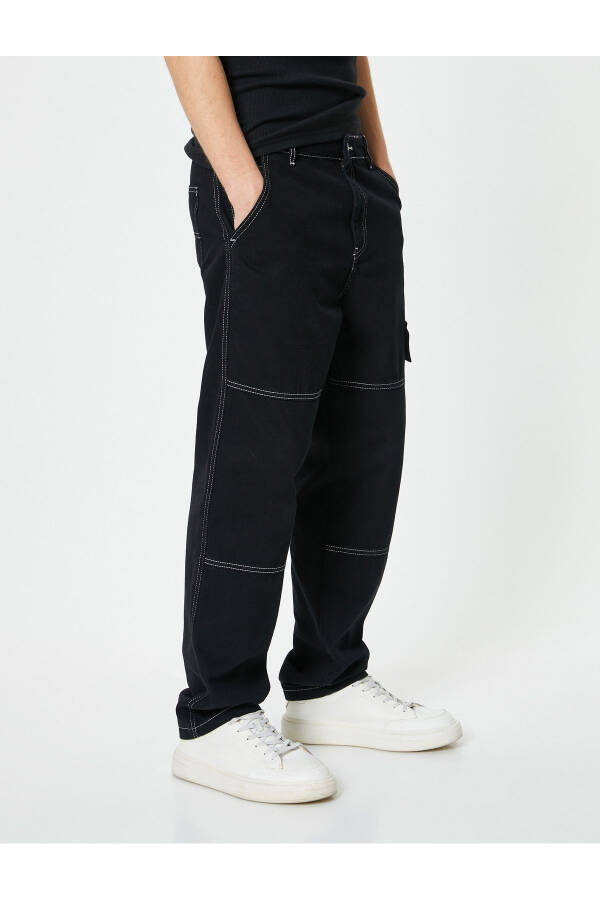 Oversized denim pants with cargo pockets, stitch detailing and buttons. - 11