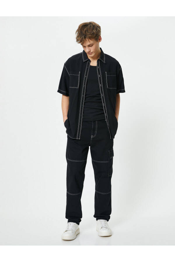 Oversized denim pants with cargo pockets, stitch detailing and buttons. - 1