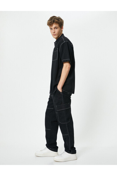 Oversized denim pants with cargo pockets, stitch detailing and buttons. - 2