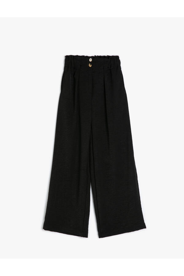 Palazzo pants with wide legs, elastic waistband and button details. - 4