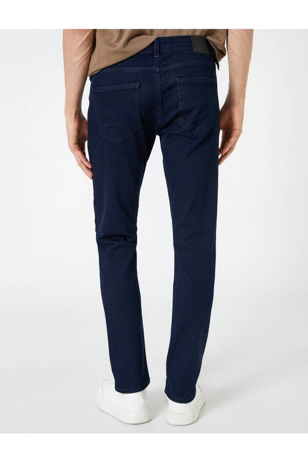 Slim fit jeans with pockets and buttons. - 2