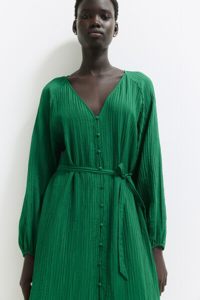 Woman in a green crepe dress with a green belt - 1