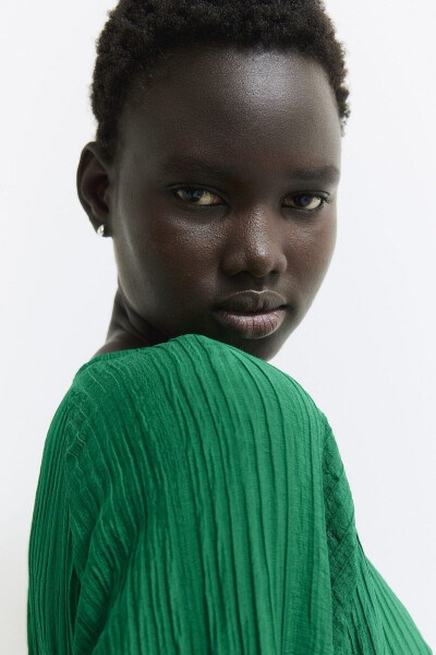 Woman in a green crepe dress with a green belt - 5