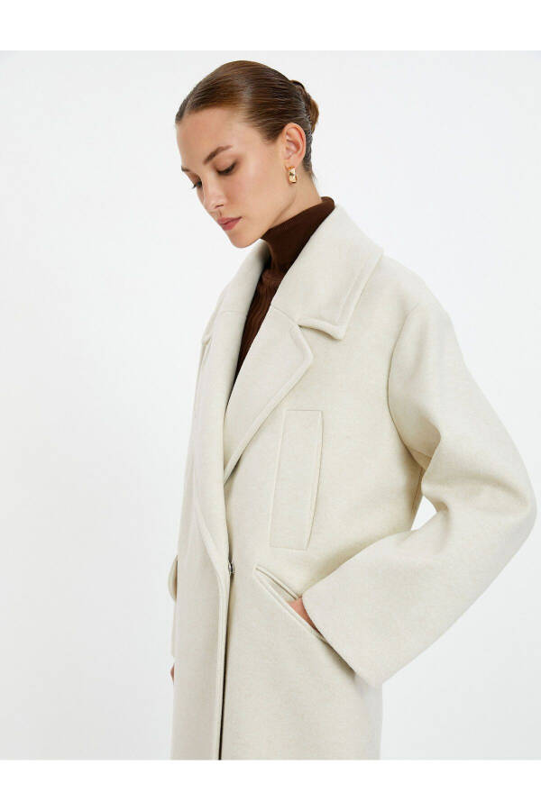 Wool coat with double-breasted closure and hidden pocket detail. - 8