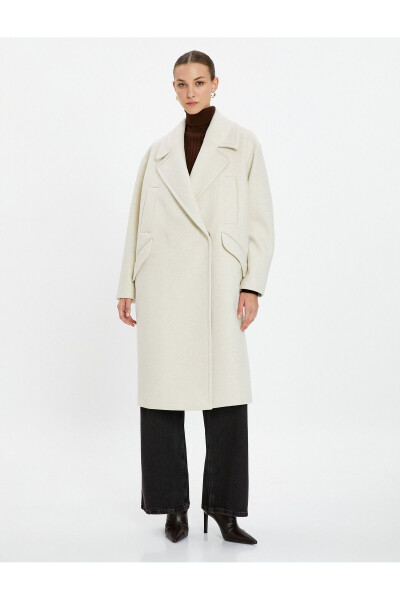 Wool coat with double-breasted closure and hidden pocket detail. - 10