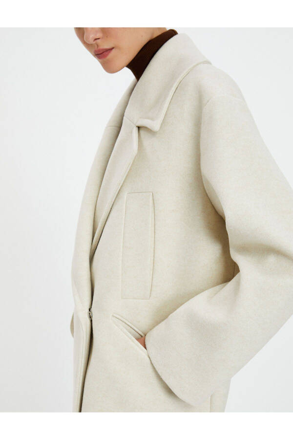 Wool coat with double-breasted closure and hidden pocket detail. - 12