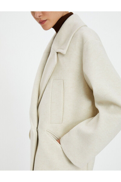 Wool coat with double-breasted closure and hidden pocket detail. - 5